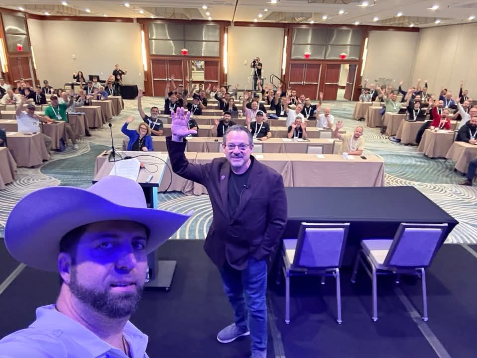 A full seminar room waving to the camera at the IKECA Fall Technical Seminar